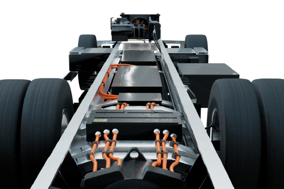 The front of a truck displaying a significant battery, highlighting its electric capabilities.