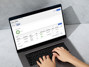 Someone typing on laptop with sustainability report on the screen