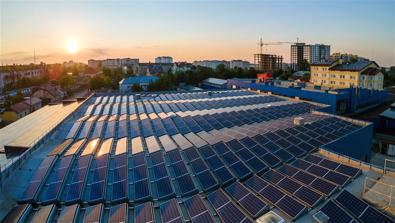 Commercial building with solar panels and heat pumps on room