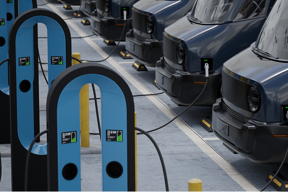 Row of commercial electric delivery fleet vehicles on chargers 