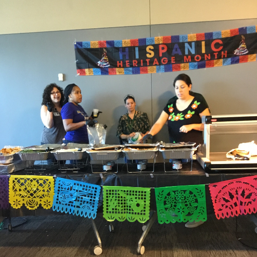 Four women prepping at decorative food station
