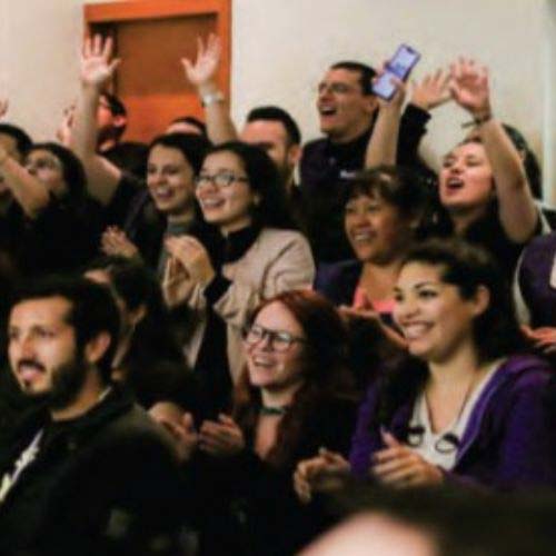 A group of Hispanic employees cheering