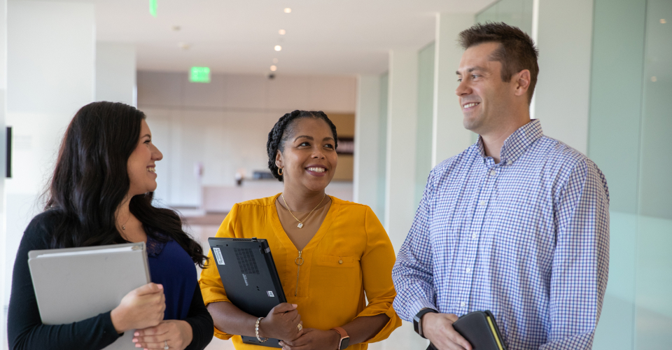 Diverse group of women and men smiling and conversing