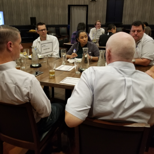 Group of people sitting around a table interacting with each other