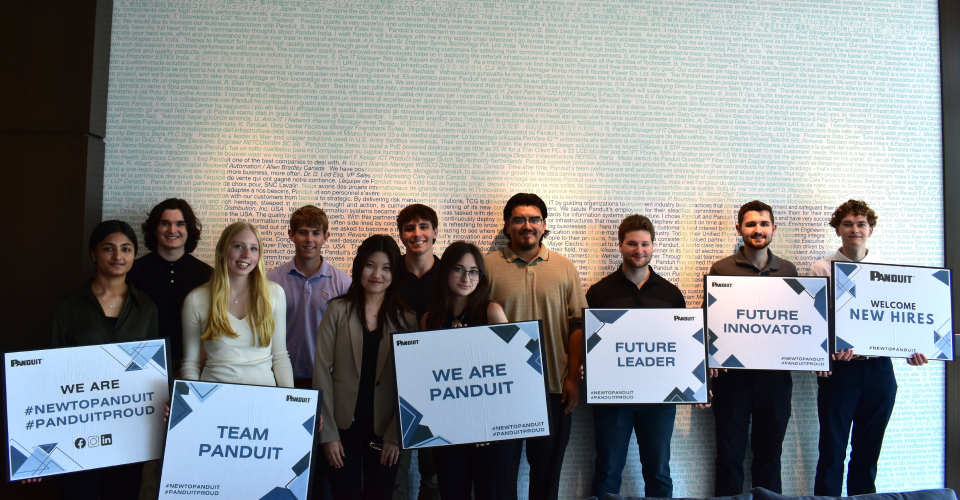 Group of new interns holding slogan signs