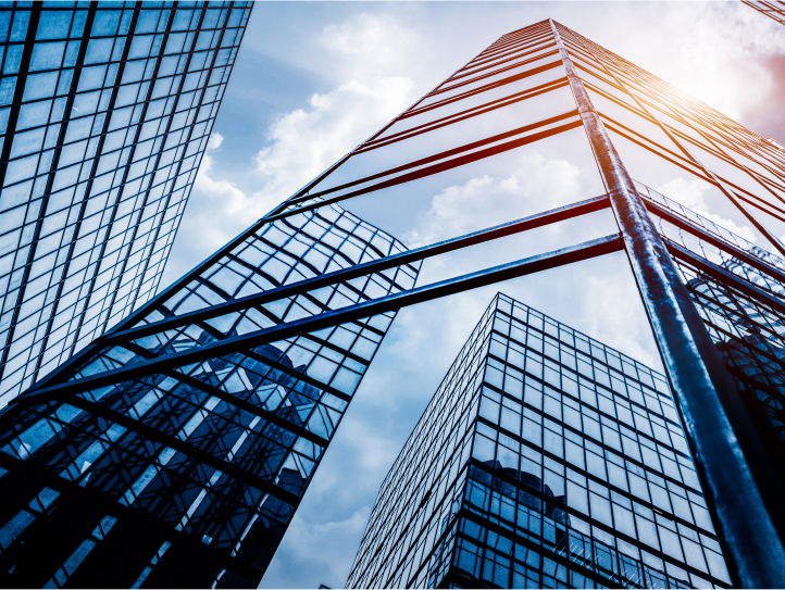 Low angle view skyscrapers outside under clouds 