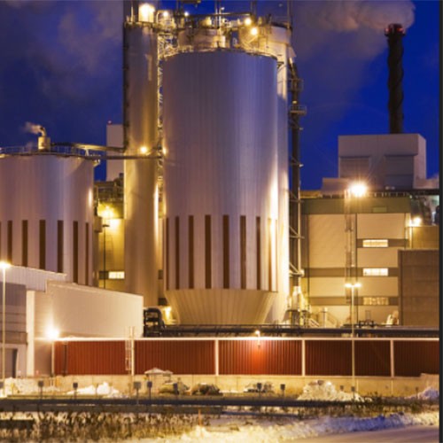 Photograph of an oil and gas refinery at night