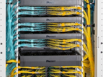 Structured cabling for fiber connectivity is shown inside the Panduit AI Network cabinet